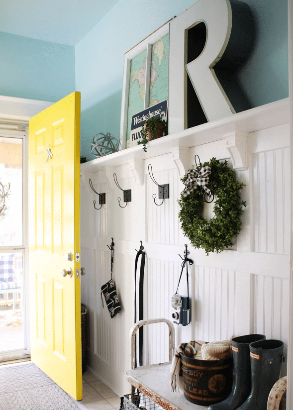 Country Coat Room With Wood Panels and Hooks