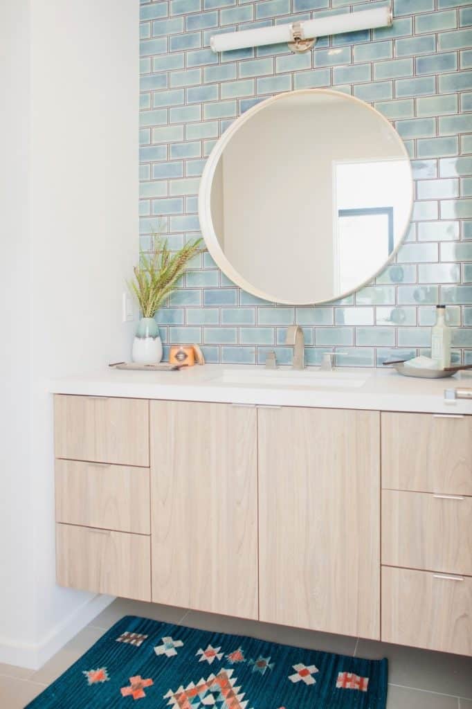 modern coastal bathroom with aqua color backsplash