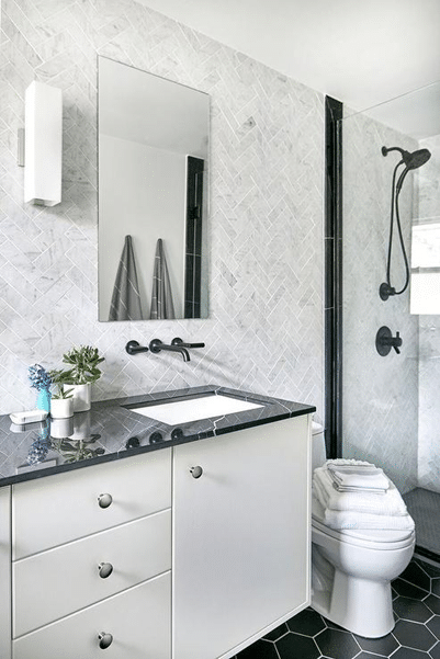 white bathroom with dark sink tap