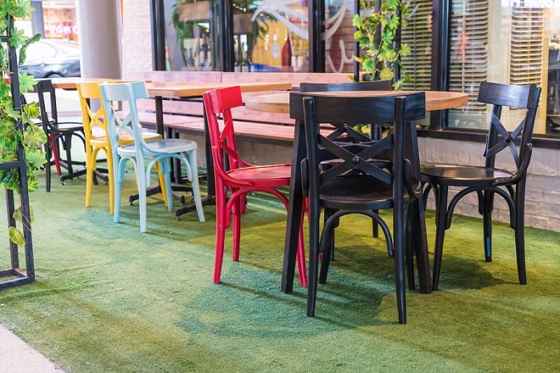 restaurant setting with wooden chairs tables