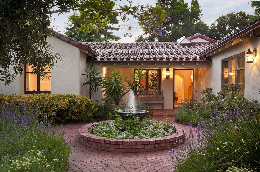 A picturesque home with a charming fountain in the front yard, showcasing the perfect blend of elegance and adaptability