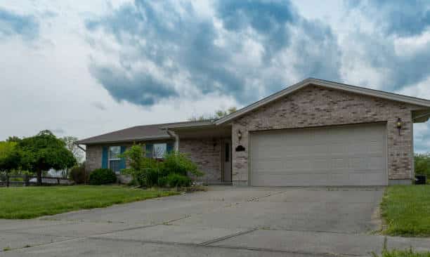 A house with a garage and a driveway. Explore the outdoor area.