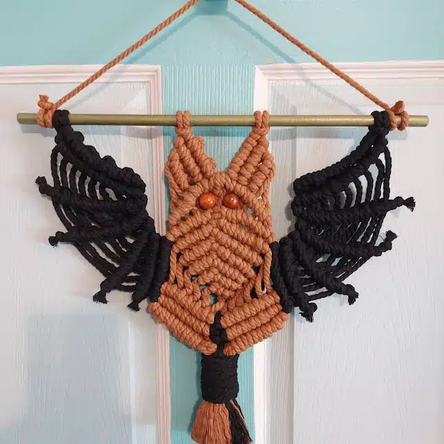 Dark macrame bat hanging as wall decoration