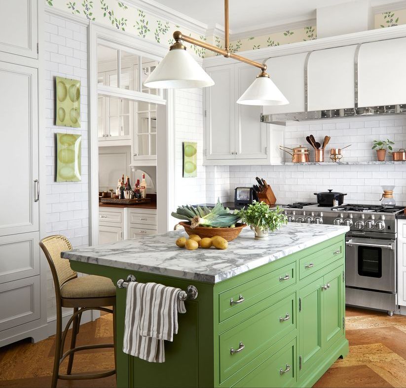 Contemporary kitchen with green cabinets and white tile, ideal for modern design enthusiasts