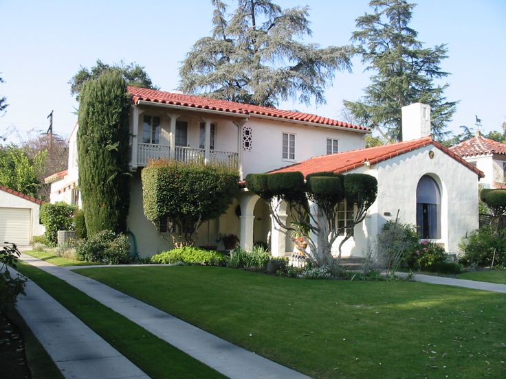 A versatile house featuring a red roof and white trim, blending elegance and charm