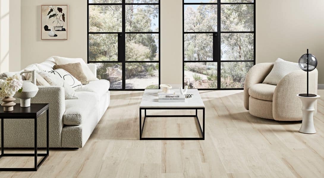 A living room with white couches and a coffee table